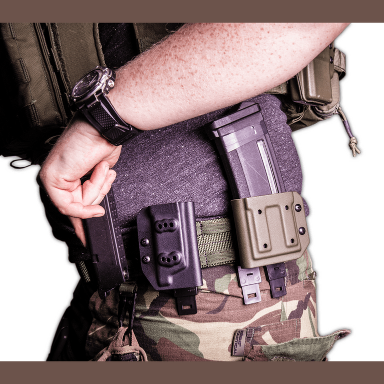 Kydex Customs 5.56 NATO magazine carrier attached to a belt, showcasing its rugged design and practical features.